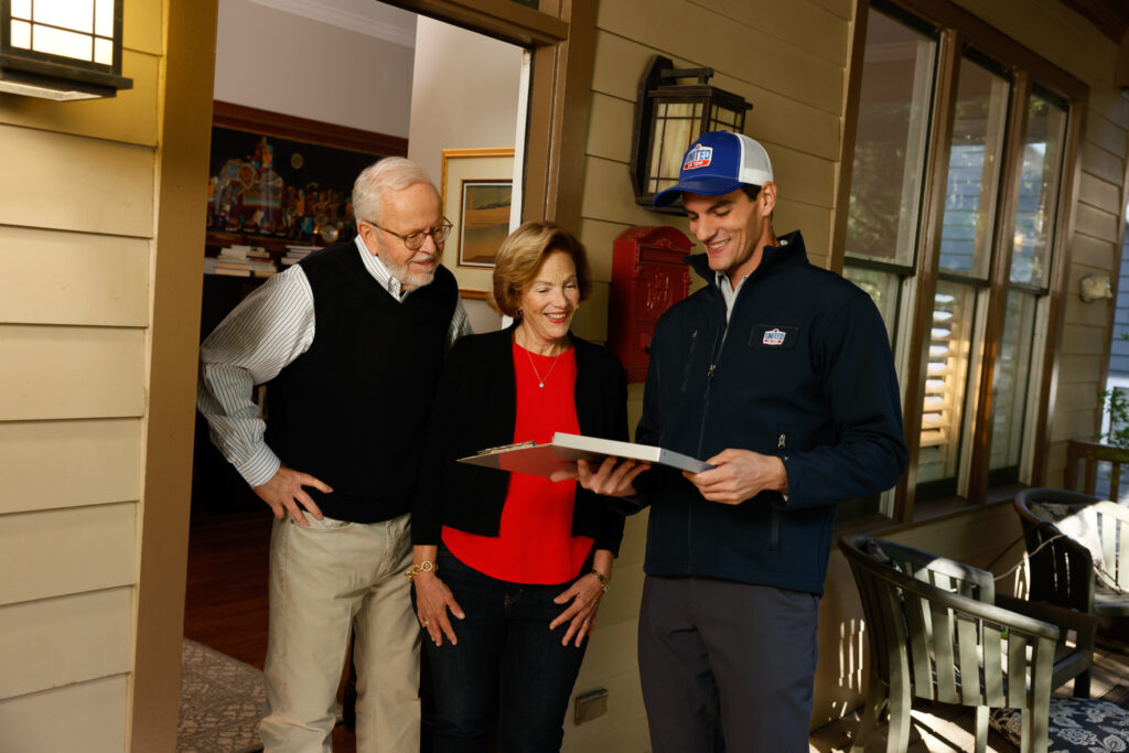 UAT technician talking to an elderly couple