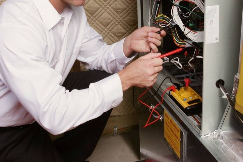 Technician completing furnace maintenance