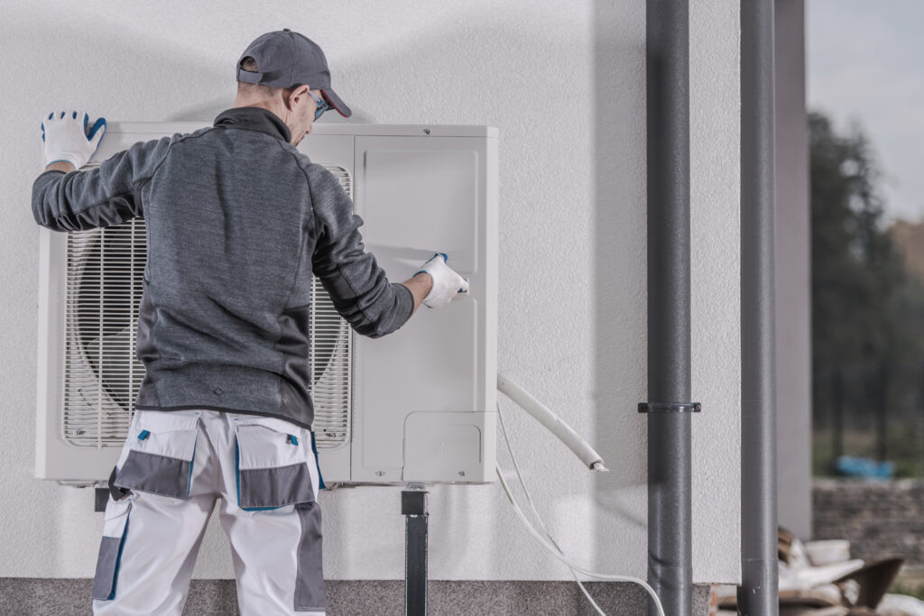 HVAC technician installing a heat pump