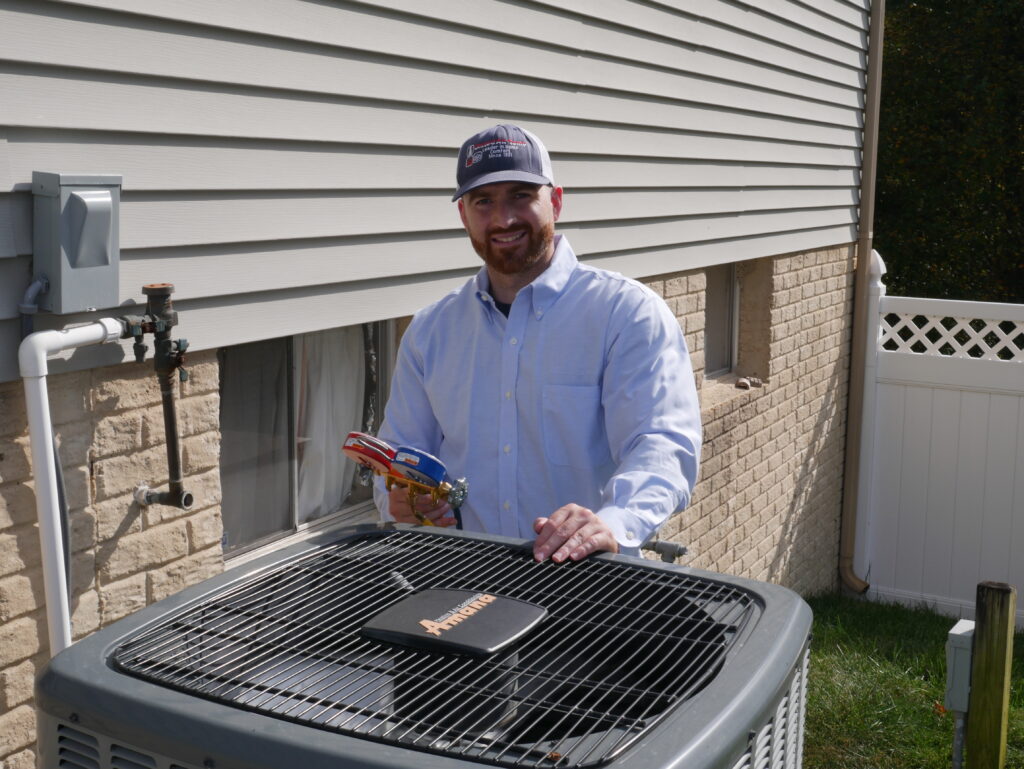 HVAC technician servicing an air conditioner