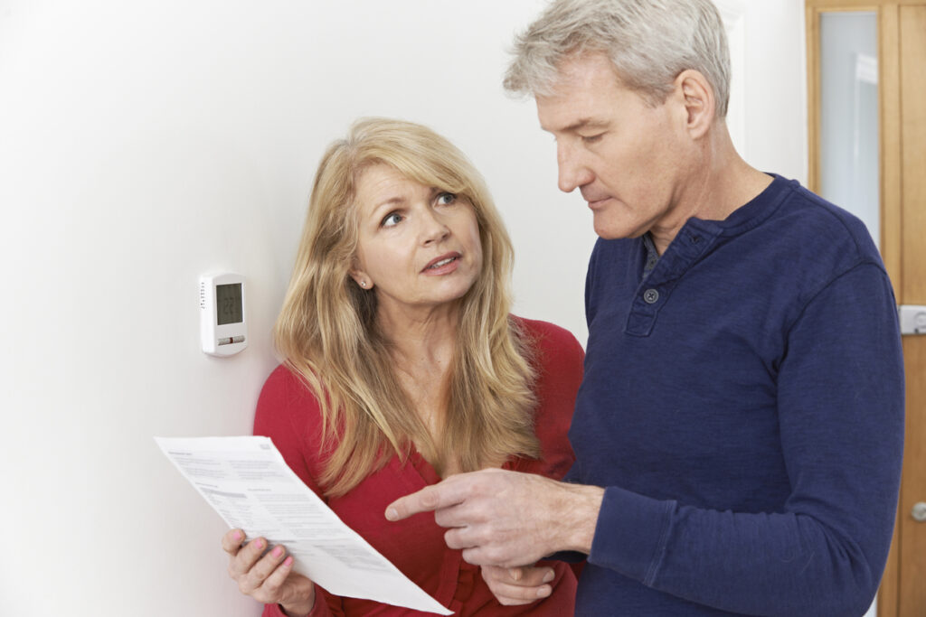 Worried couple looking at utility bill